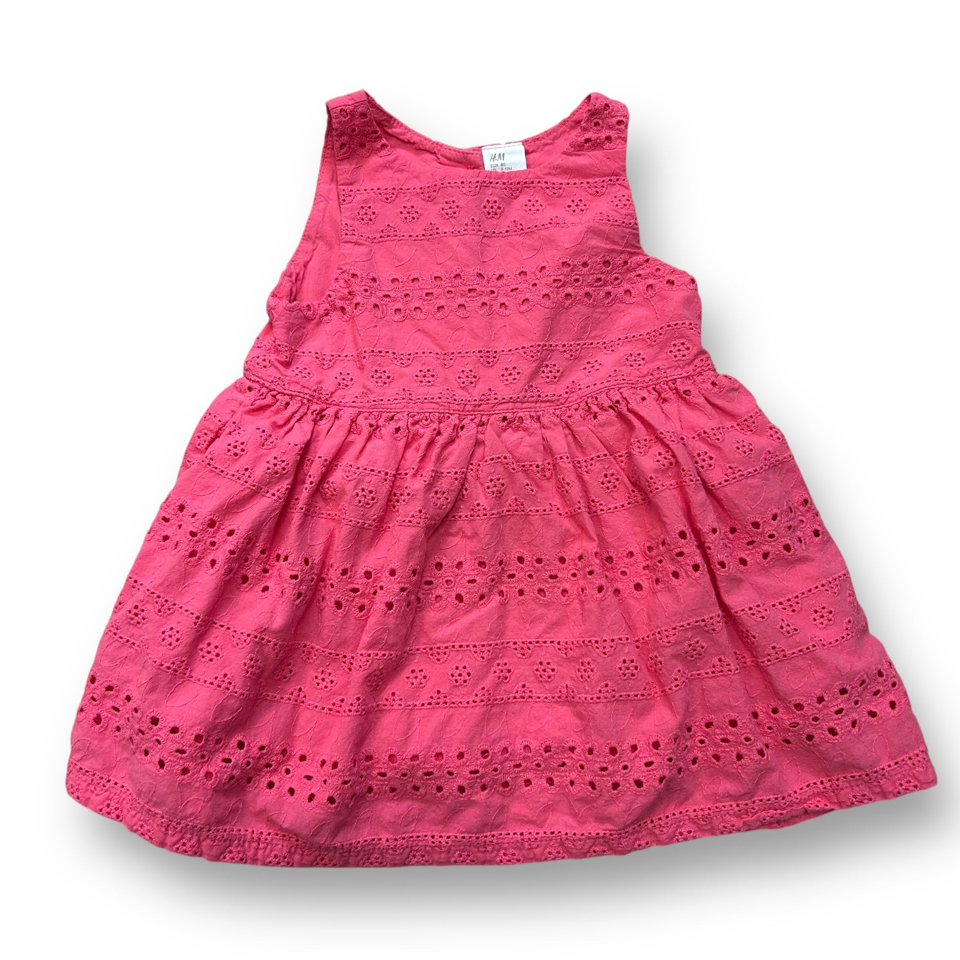 A pink sleeveless eyelet dress for girls, size 9-12 months, with a patterned design.