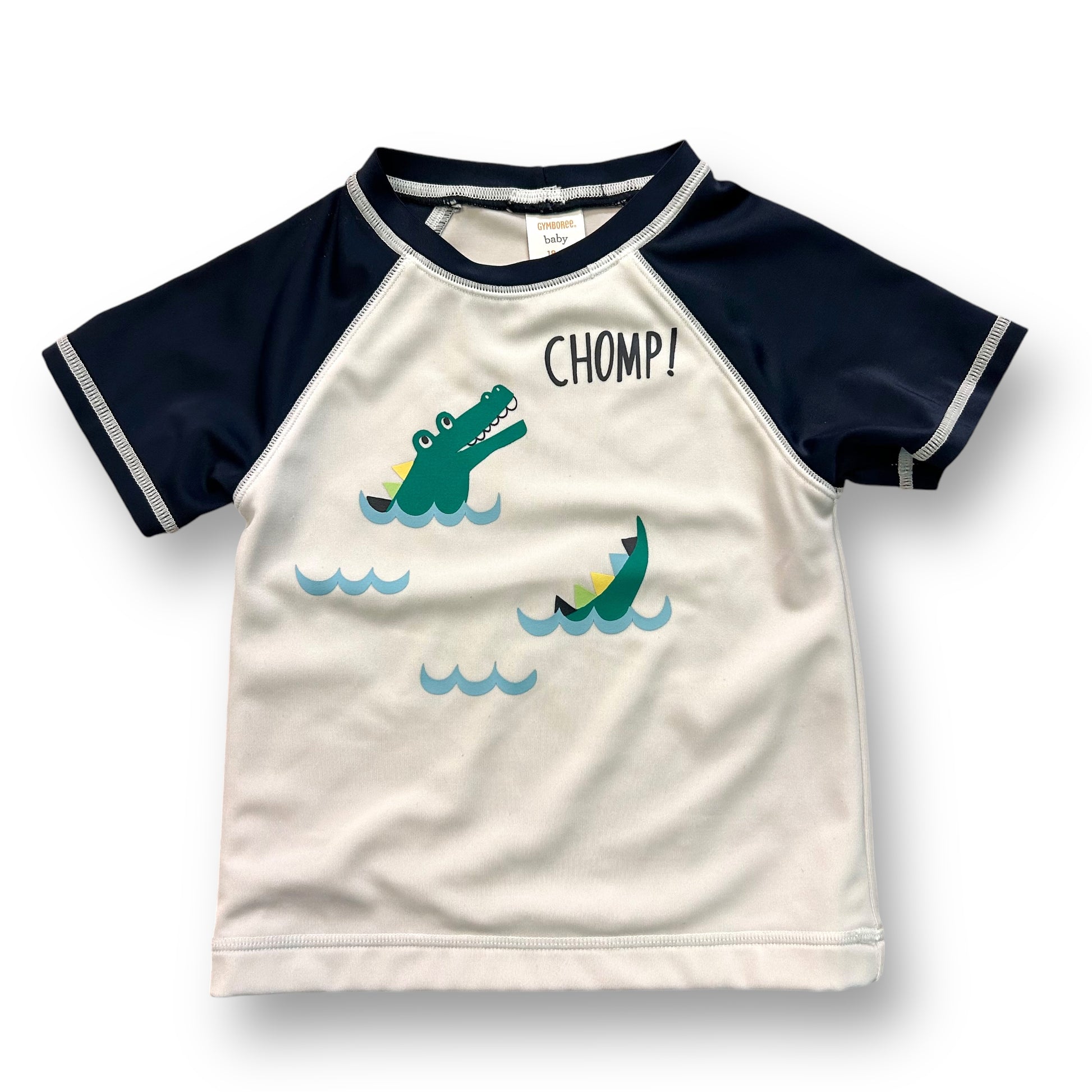 Toddler size 18-24 months swim rashguard with a white base and navy blue trim, featuring alligator graphics and the word 'CHAMP!' on the front.