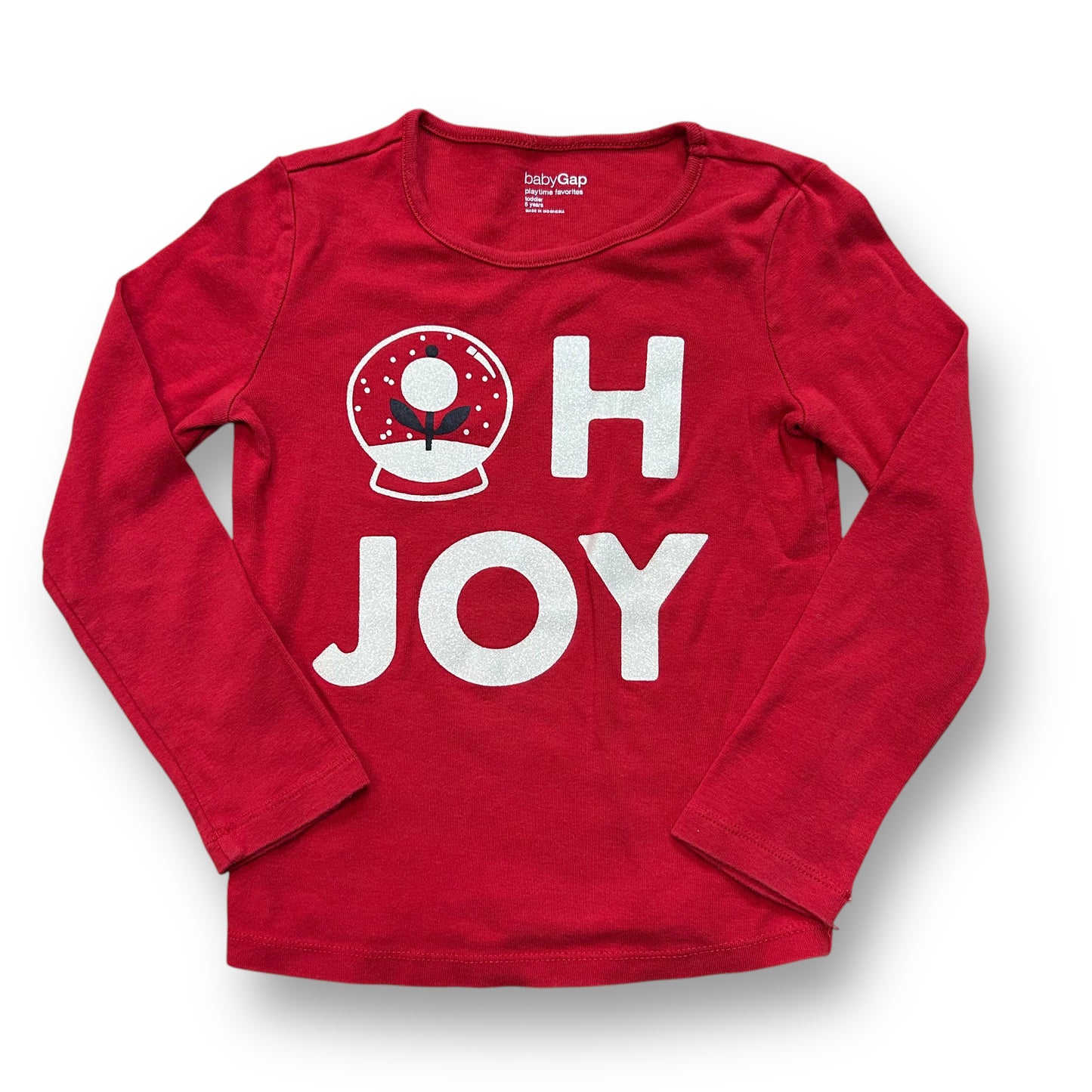 A long sleeve red Christmas shirt with 'Oh Joy' text and a circular design with a Christmas theme.