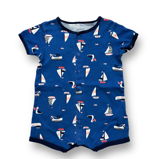 A blue and white sailboat-themed one-piece short sleeve snap leg garment for a baby boy.