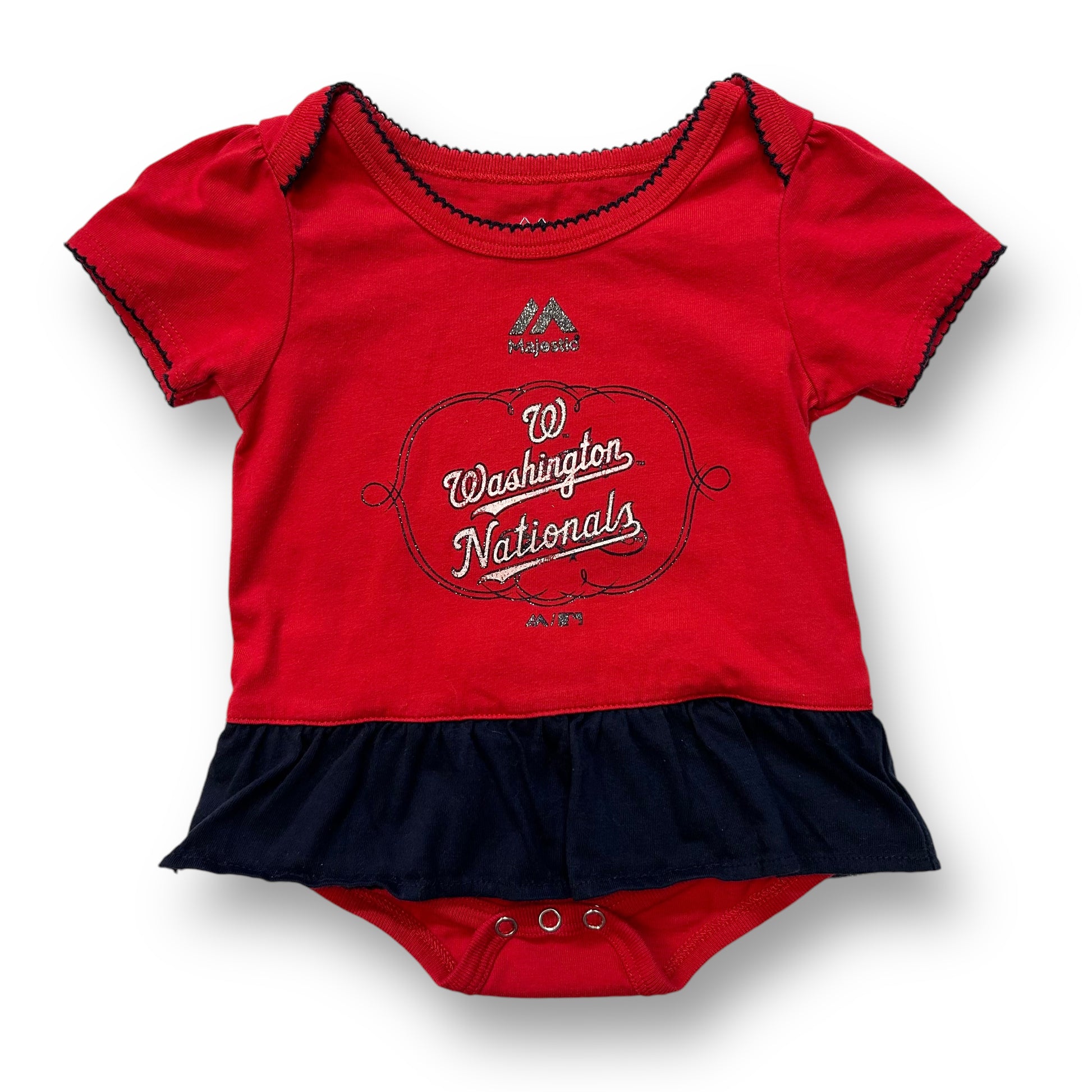 A red and blue baby onesie with the Washington Nationals logo on it.
