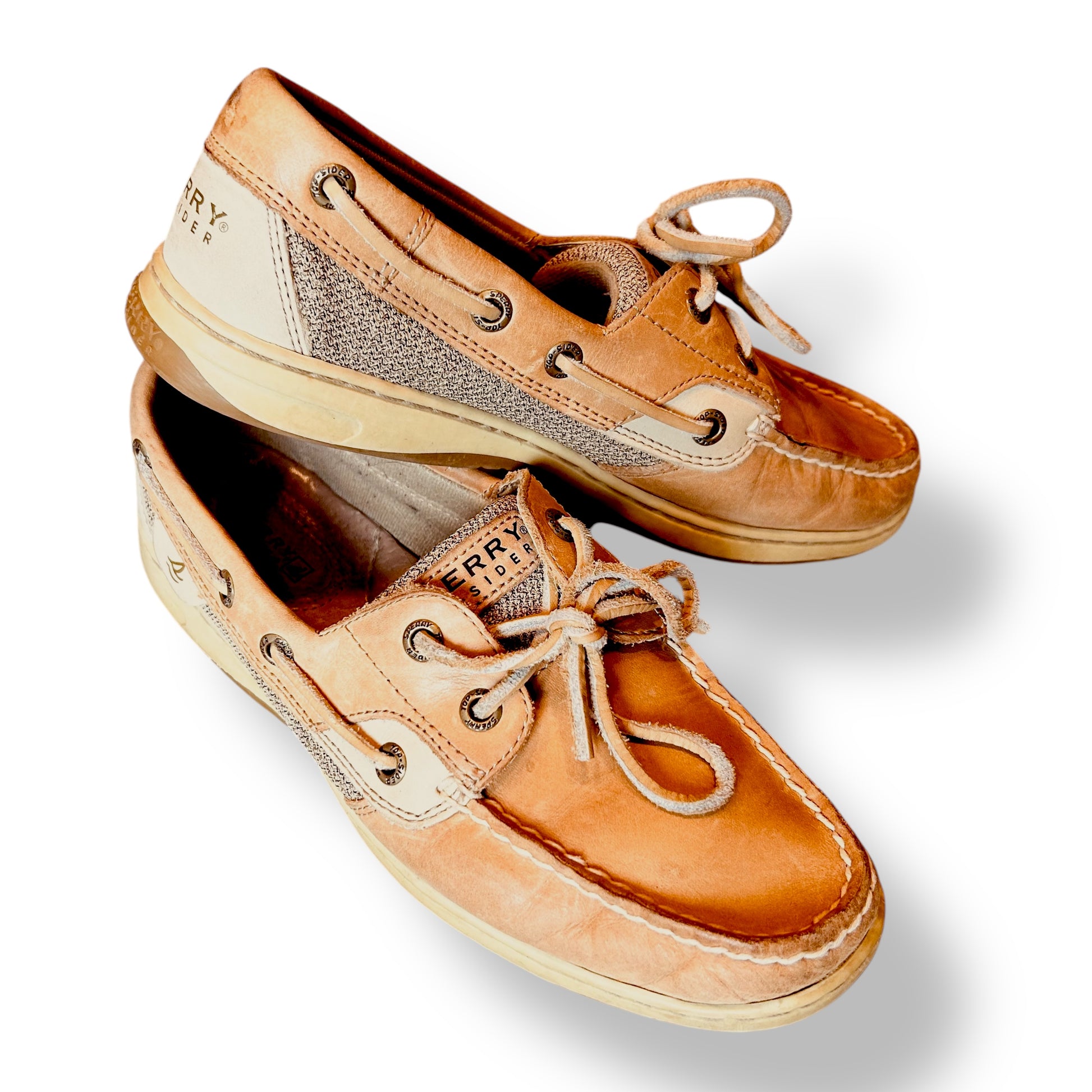 A pair of Sperry Top Sider women's tan leather casual slip-on boat shoes.