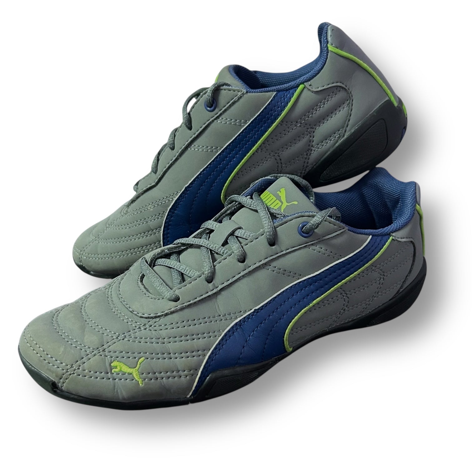 Gray and blue Puma sneakers with a visible brand logo on a white background
