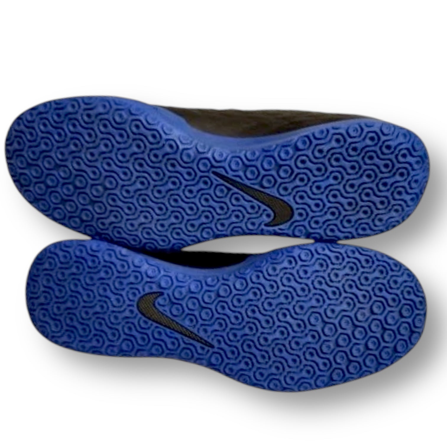 Blue shoe soles with a Nike logo on a white background