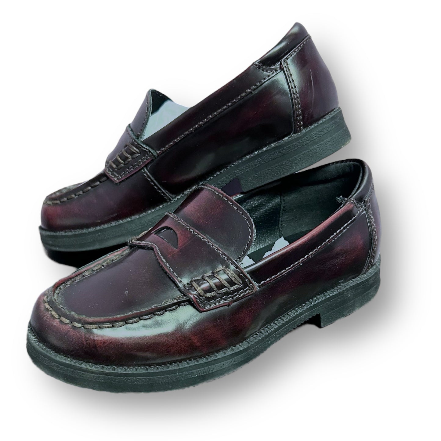 Pair of dark brown loafers on a white background