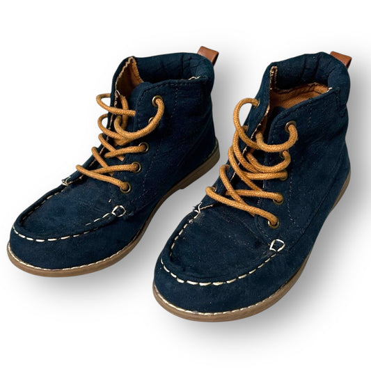 Pair of navy blue boots with brown laces on a white background