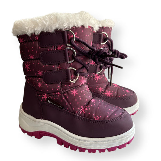 Purple winter boots with pink snowflake pattern and white fur lining on a white background