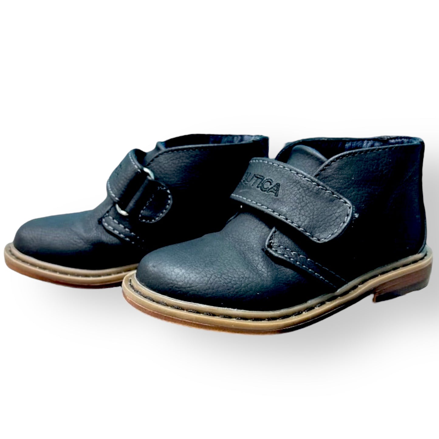 Pair of navy blue children's shoes with velcro straps on a white background