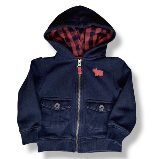 Navy blue hoodie with plaid lining on a white background