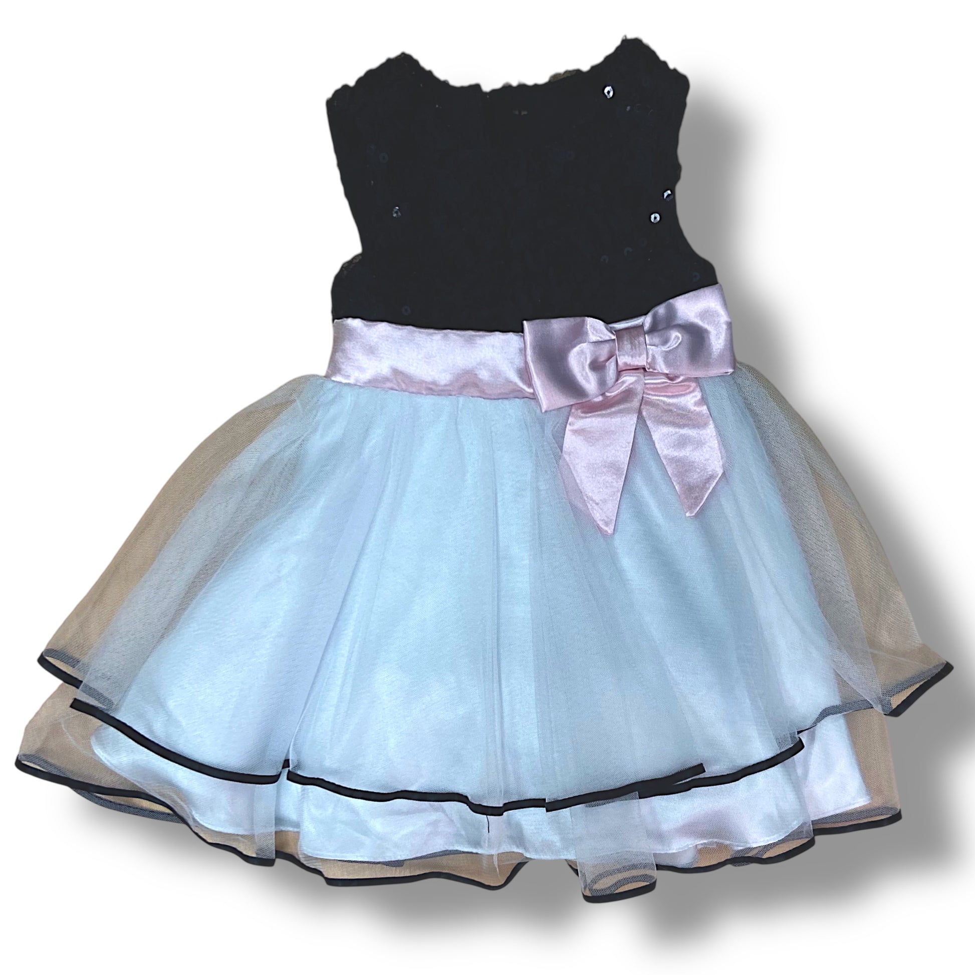 Black top and light blue tulle skirt dress with a pink bow on a white background