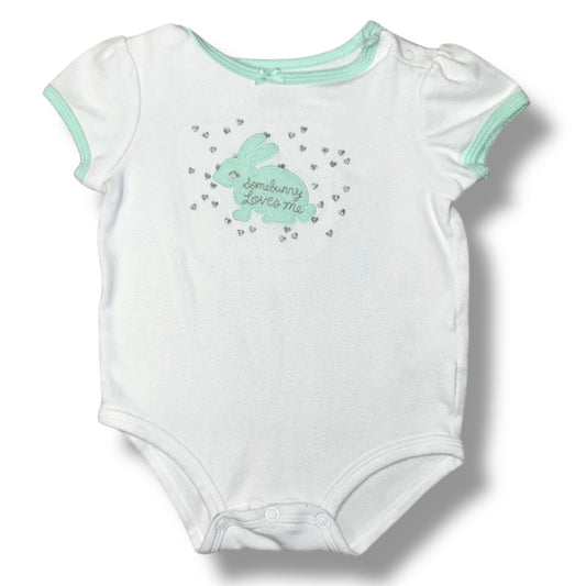 White baby onesie with green bunny design and text on a white background