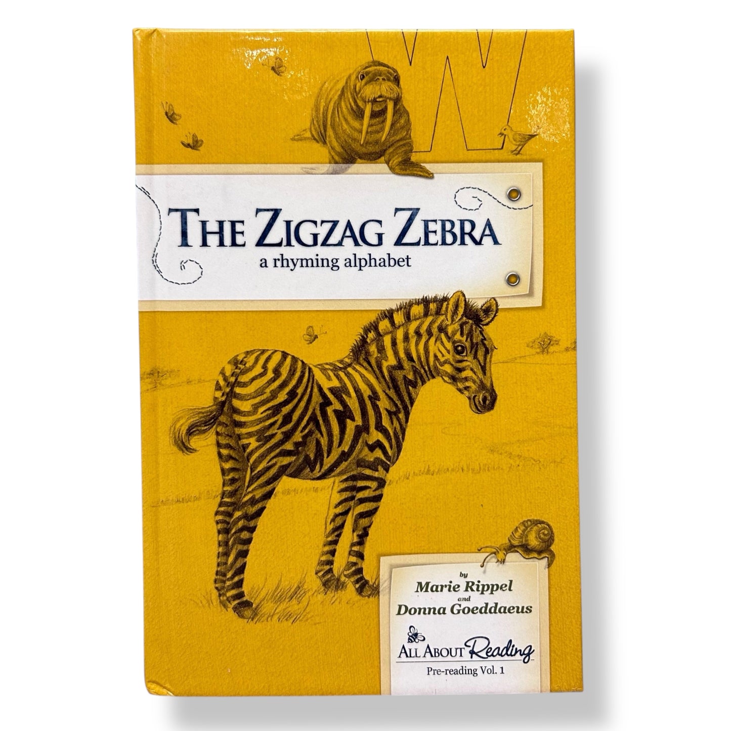 Book cover of 'The Zigzag Zebra' with a zebra illustration on a yellow background