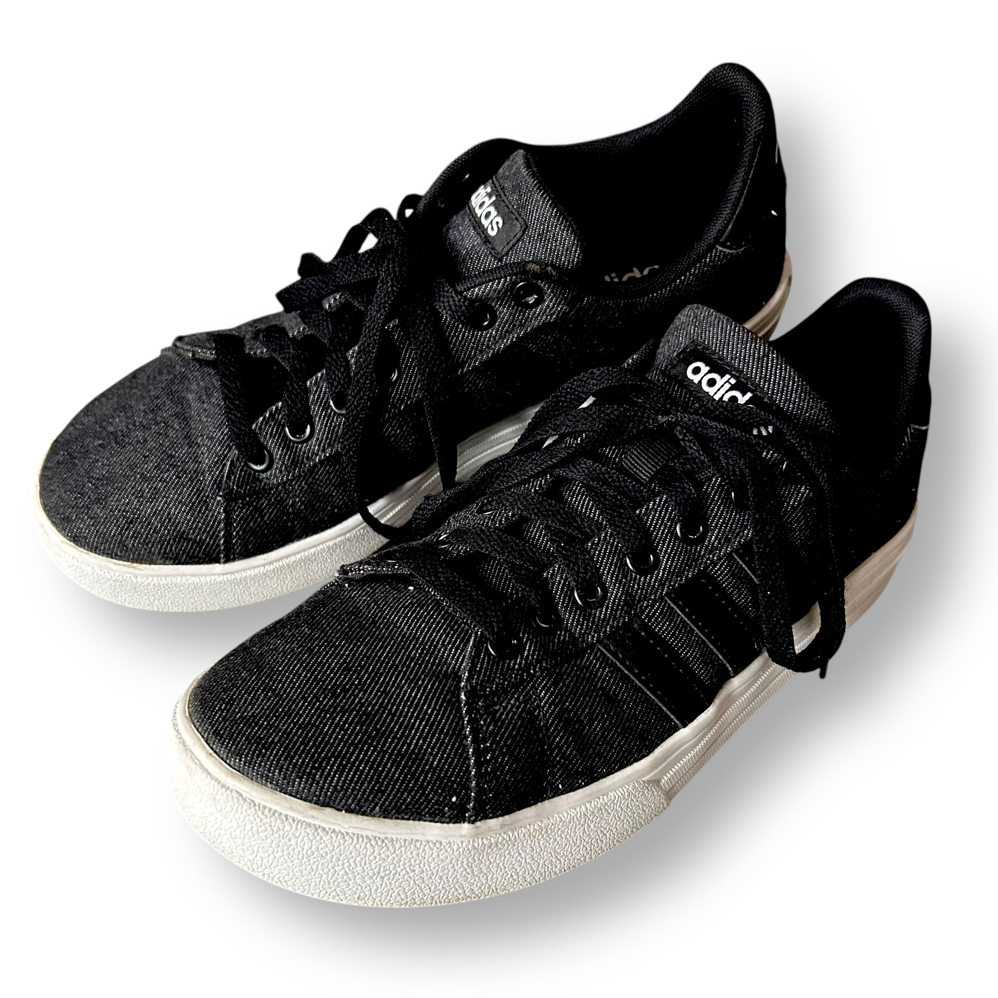 Black sneakers with white soles on a white background