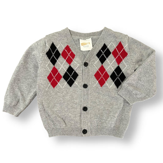 Gray children's sweater with argyle pattern on a white background