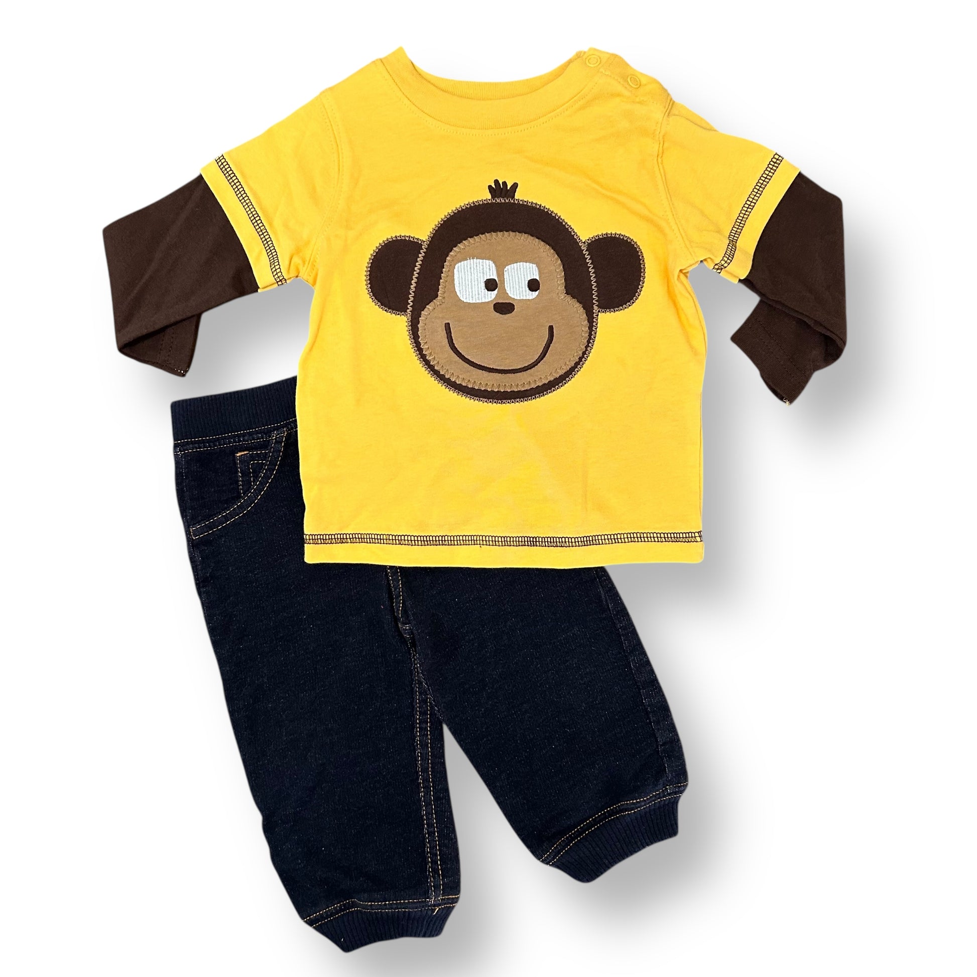 Yellow shirt with monkey design and dark blue pants on a white background