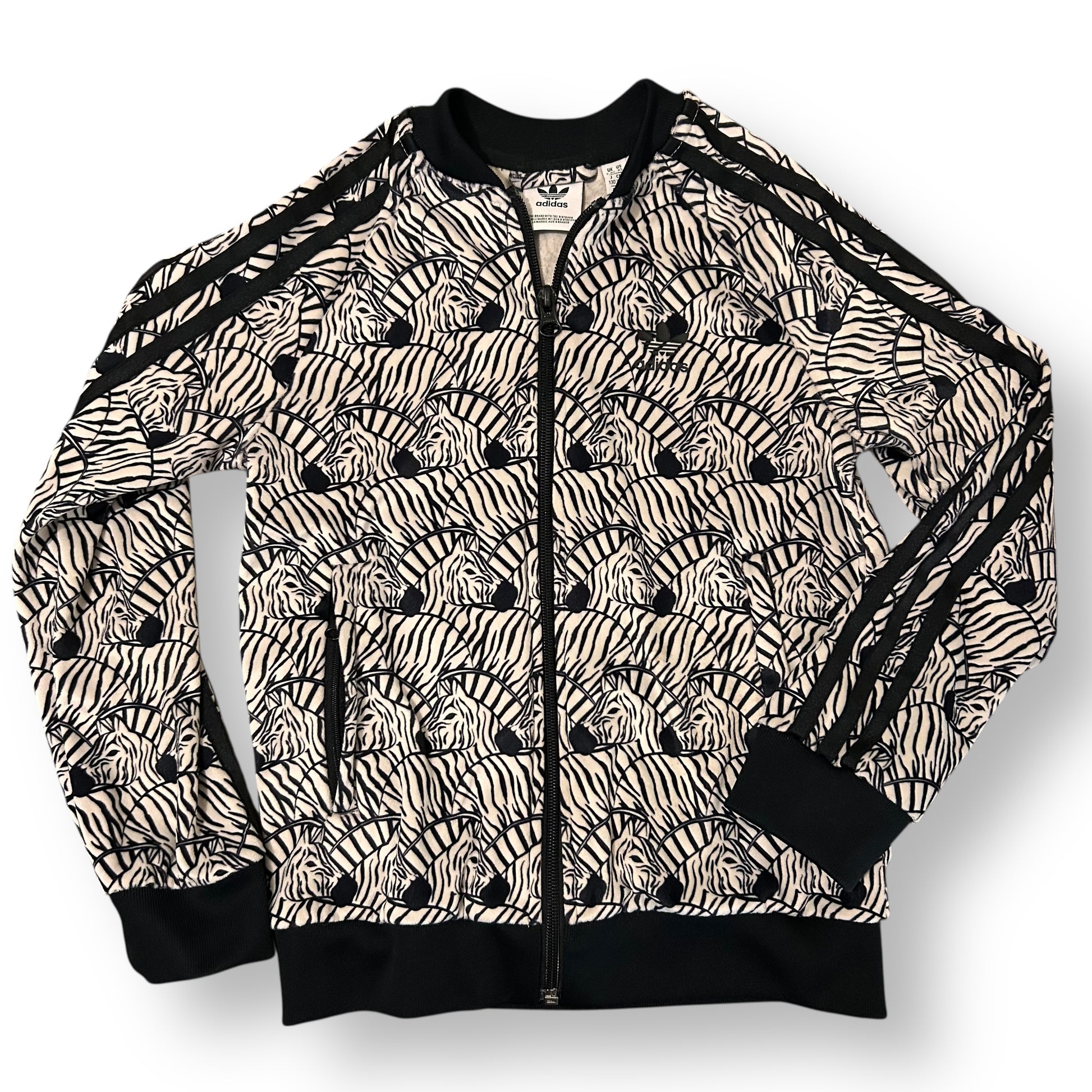 Zebra patterned jacket with black accents on a white background
