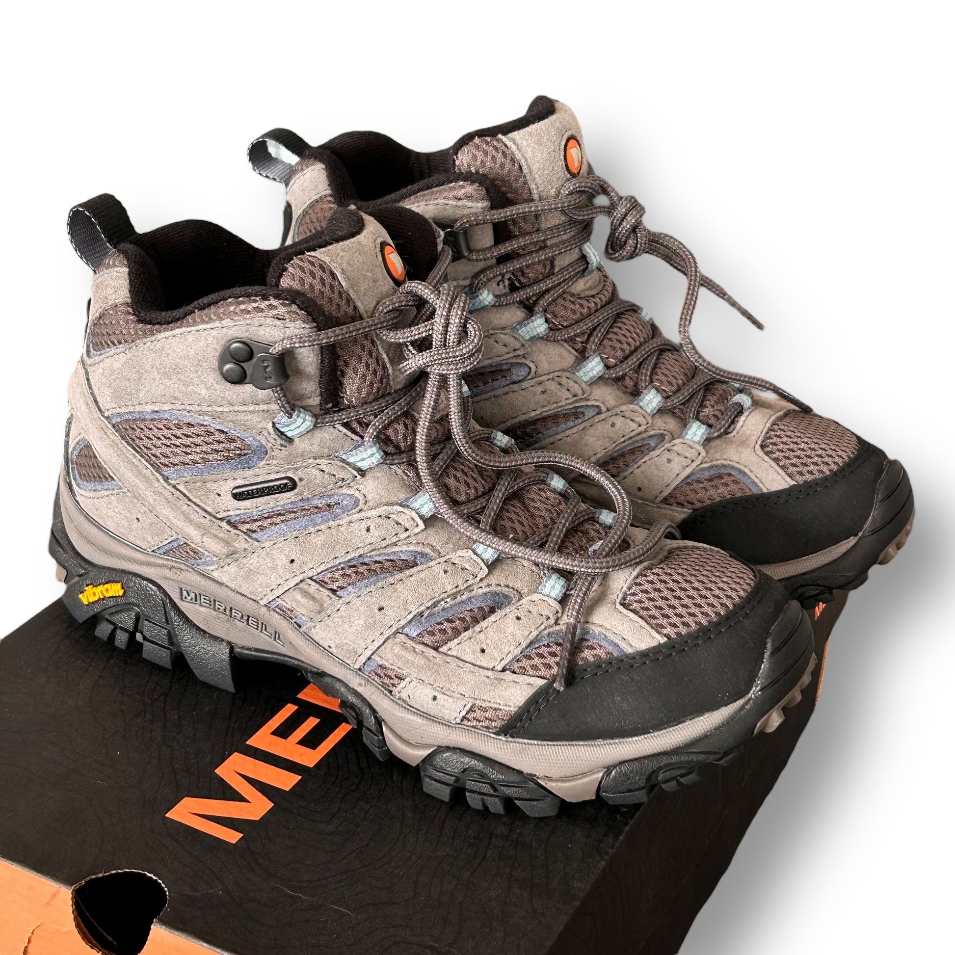 Pair of Merrell gray hiking boots with a visible brand logo on a white background