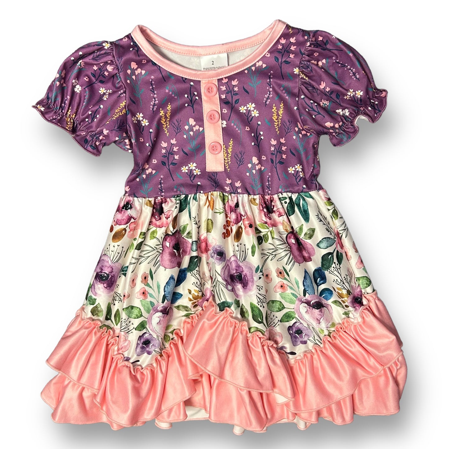 A dress for girls featuring a pink and purple floral print with a round neckline and short sleeves.