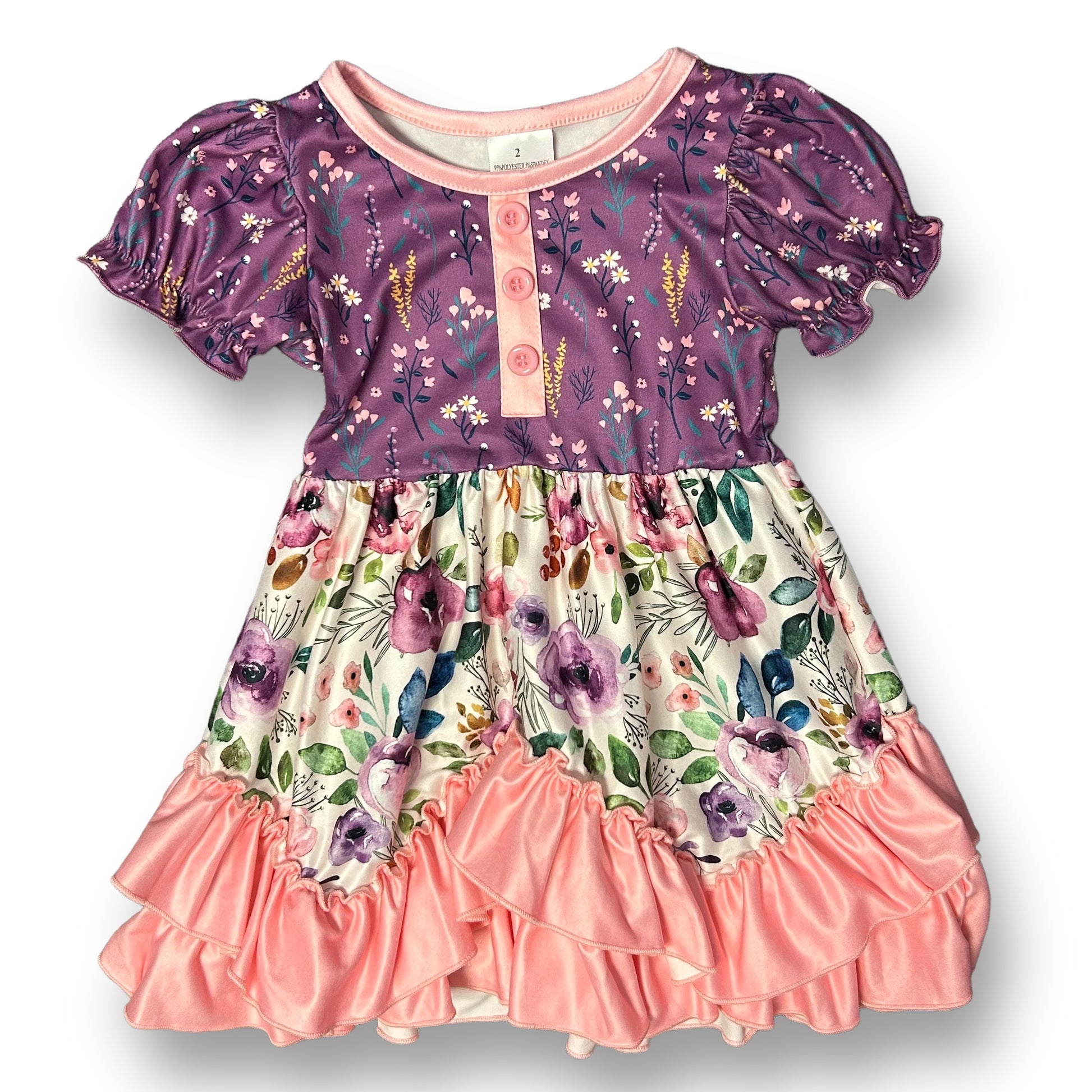 A dress for girls featuring a pink and purple floral print with a round neckline and short sleeves.