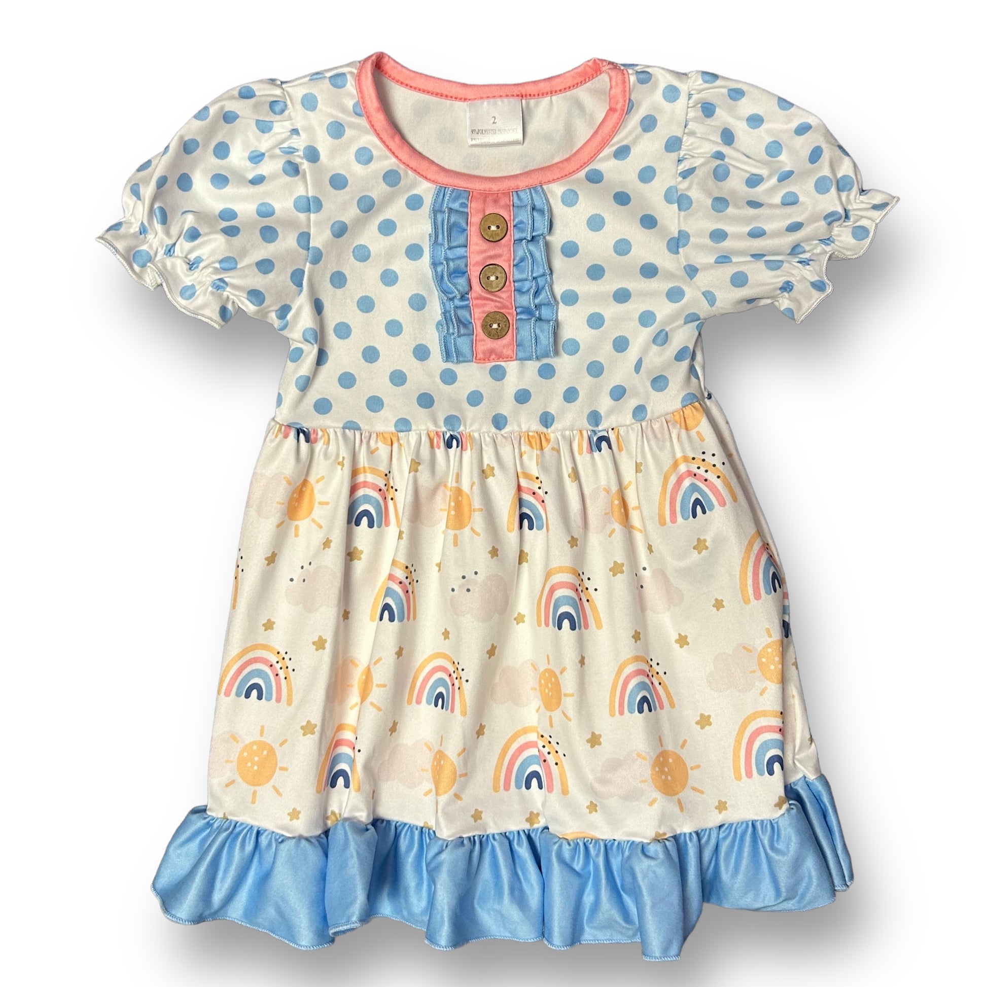 A white dress with a polka dot and rainbow pattern, featuring a ruffled skirt and a pink-accented bodice.