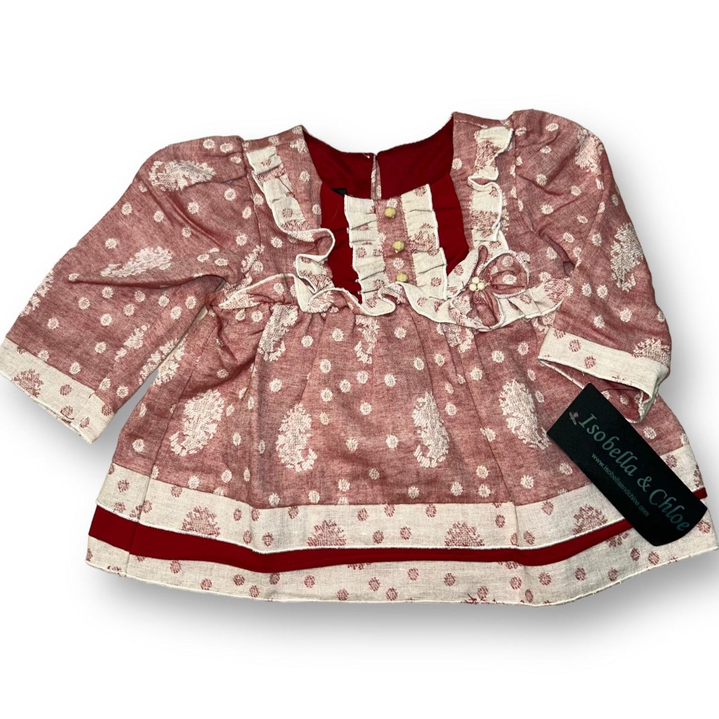A red and beige Isobella & Chloe branded rufle cotton boutique blouse for girls, featuring a ruffled collar and long sleeves.