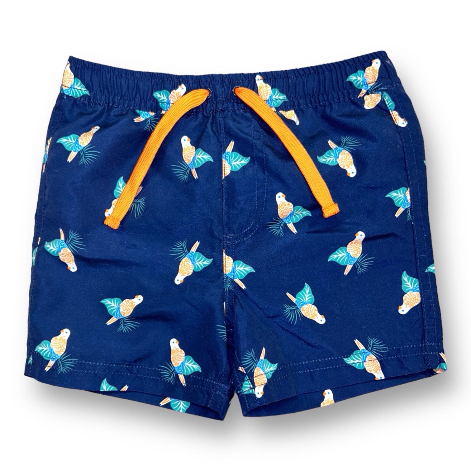Dark blue swim trunks for boys with a tropical birdie pattern and orange tags.