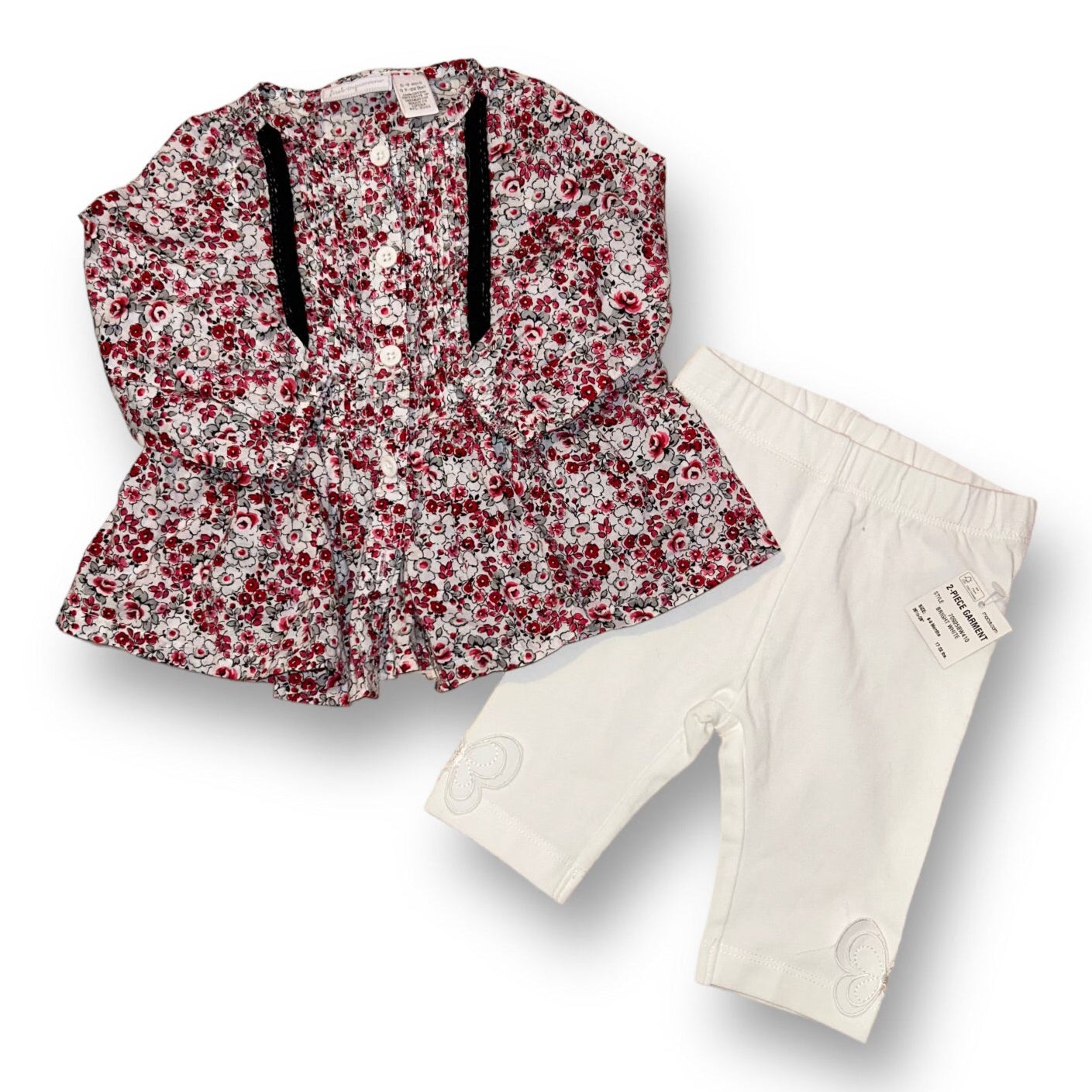 A floral babydoll blouse and matching bottoms for girls, with a predominantly white color scheme and red floral patterns.